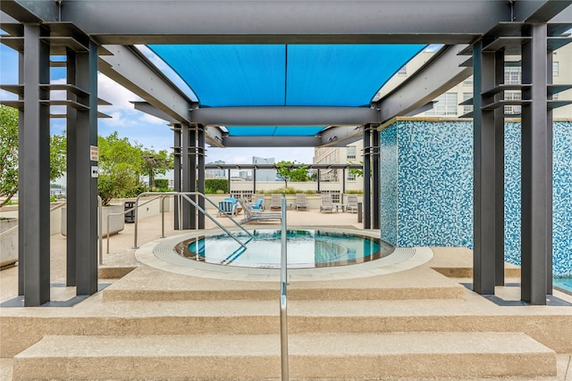 view of pool featuring a hot tub and a patio