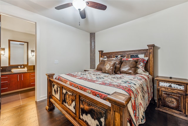 bedroom featuring dark tile floors, ceiling fan, and sink