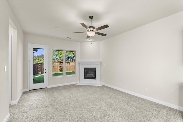 unfurnished living room featuring ceiling fan and light carpet