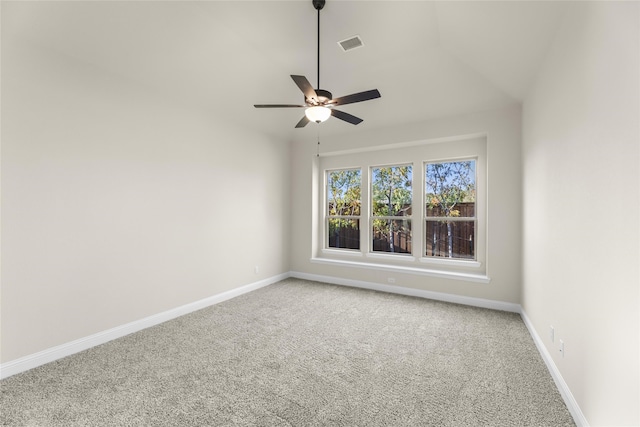 empty room with carpet floors, vaulted ceiling, and ceiling fan