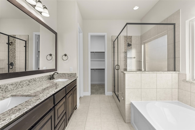 bathroom with tile patterned flooring, vanity, and shower with separate bathtub