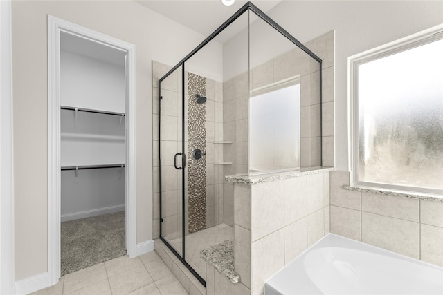 bathroom with tile patterned flooring and independent shower and bath