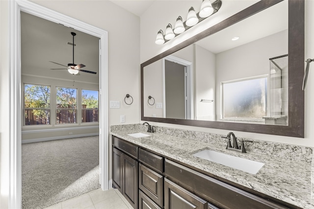 bathroom with tile patterned flooring, vanity, and ceiling fan