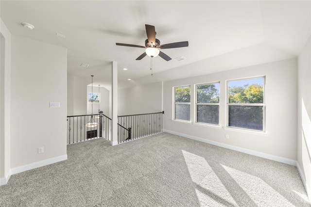 empty room featuring ceiling fan and carpet