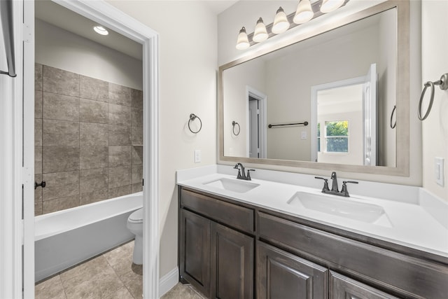 full bathroom featuring vanity, toilet, and tiled shower / bath combo