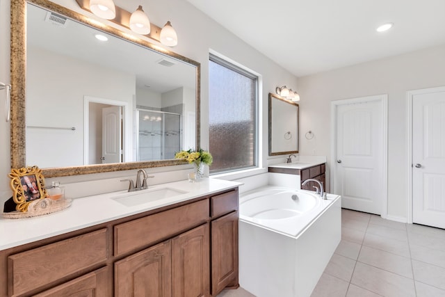 bathroom featuring independent shower and bath, tile patterned flooring, vanity, and a healthy amount of sunlight