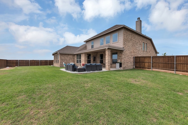 back of house with an outdoor hangout area, a yard, and a patio