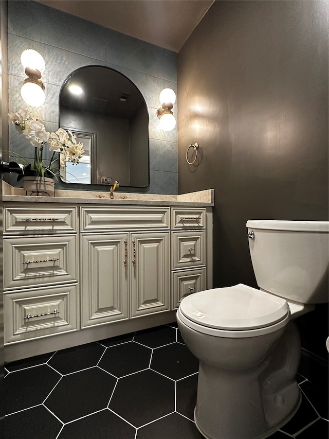 bathroom with vanity, toilet, and tile floors