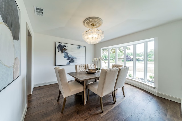 dining space featuring dark hardwood / wood-style floors, plenty of natural light, and a chandelier