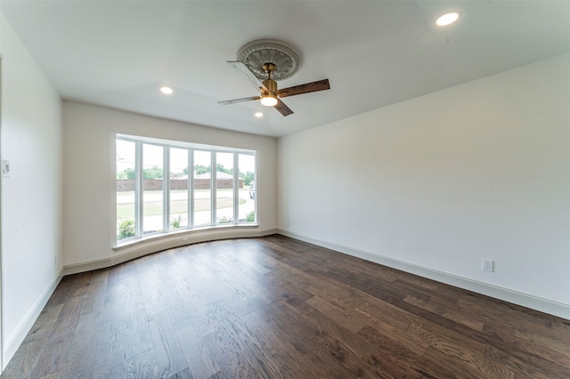 empty room with hardwood / wood-style floors and ceiling fan