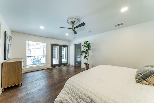 bedroom featuring access to outside, dark hardwood / wood-style flooring, ceiling fan, and french doors