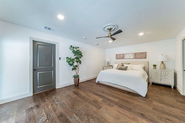 bedroom with dark hardwood / wood-style flooring and ceiling fan