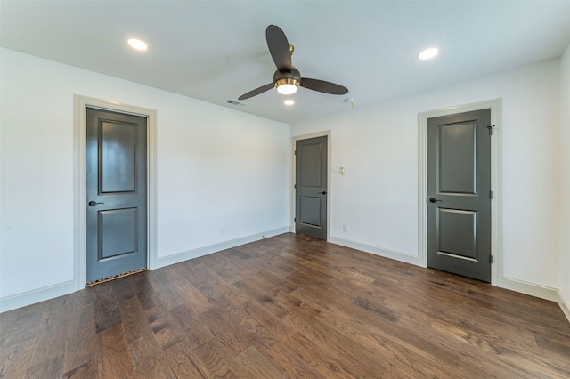 empty room with ceiling fan and dark wood-type flooring