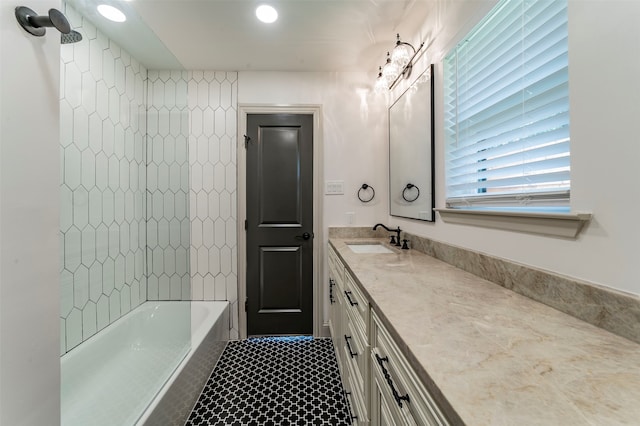 bathroom featuring vanity, tiled shower / bath combo, and tile floors