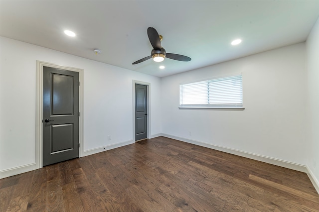 unfurnished bedroom featuring dark hardwood / wood-style floors and ceiling fan