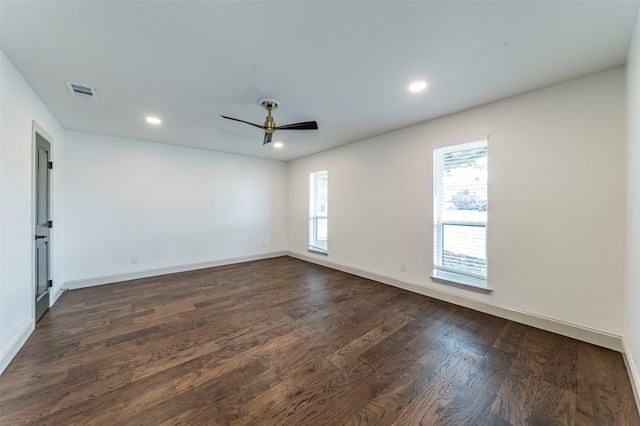 empty room with ceiling fan and dark hardwood / wood-style floors