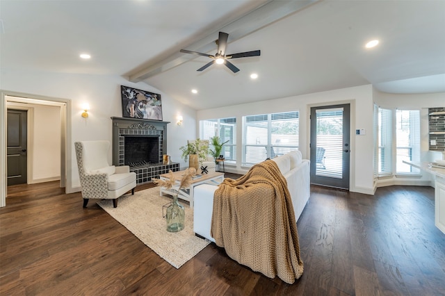 living room with a wealth of natural light, dark hardwood / wood-style floors, a fireplace, and lofted ceiling with beams