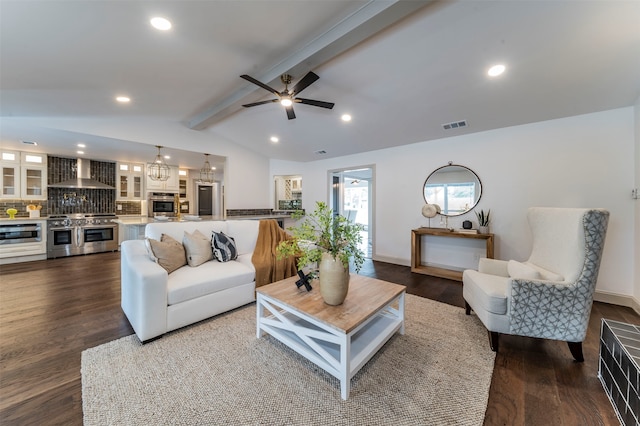 living room featuring dark hardwood / wood-style flooring, ceiling fan, vaulted ceiling with beams, and a fireplace