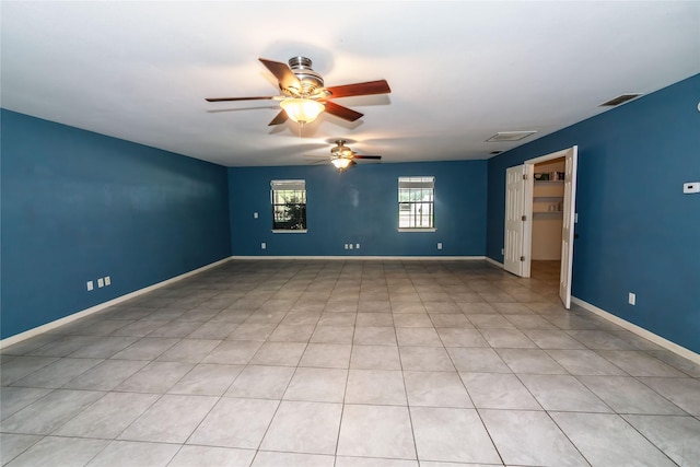 unfurnished room featuring a ceiling fan, visible vents, and baseboards