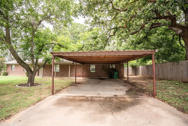 view of car parking with a carport and a yard