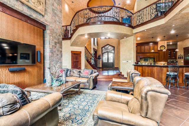 living room featuring tile flooring and a high ceiling