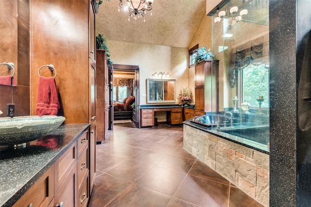 bathroom with lofted ceiling, tile patterned flooring, connected bathroom, vanity, and tiled tub