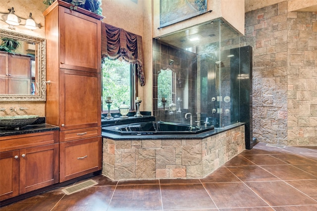 full bathroom with tile patterned flooring, visible vents, walk in shower, and vanity