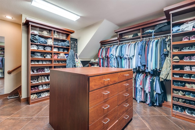 walk in closet featuring dark tile patterned flooring