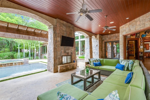 view of patio with an outdoor pool, an outdoor living space with a fireplace, ceiling fan, and an in ground hot tub