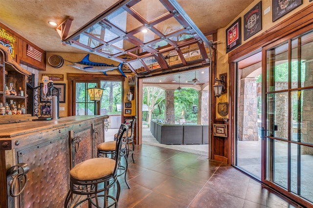 bar featuring tile floors and coffered ceiling