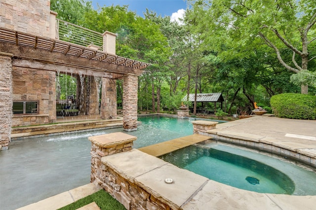 outdoor pool featuring a patio area and an in ground hot tub