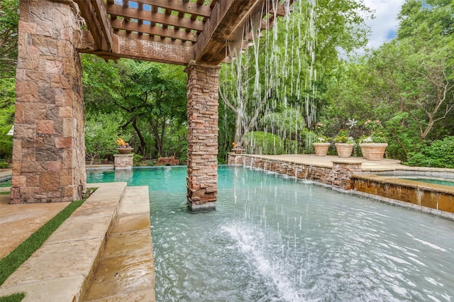 outdoor pool featuring an in ground hot tub