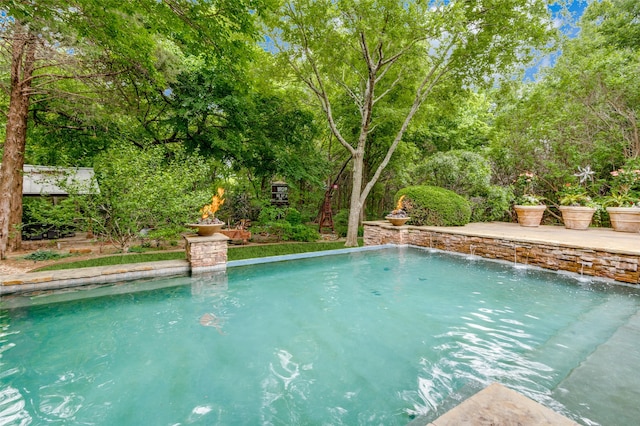 view of swimming pool featuring pool water feature