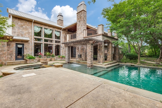 view of pool featuring pool water feature and a patio