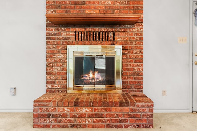 room details featuring carpet flooring and a fireplace