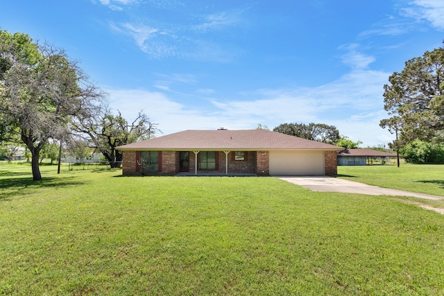 single story home featuring a garage and a front lawn