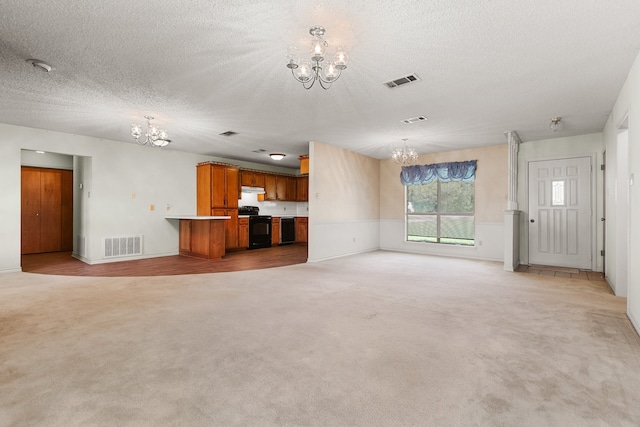 unfurnished living room with a textured ceiling, light carpet, and a notable chandelier