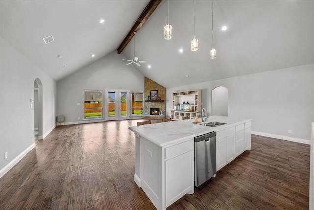 kitchen featuring dishwasher, pendant lighting, a center island with sink, beam ceiling, and sink