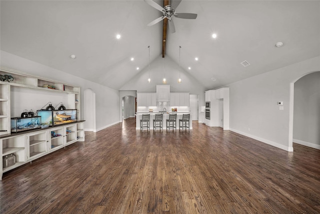 living room with high vaulted ceiling, beam ceiling, ceiling fan, and dark hardwood / wood-style flooring