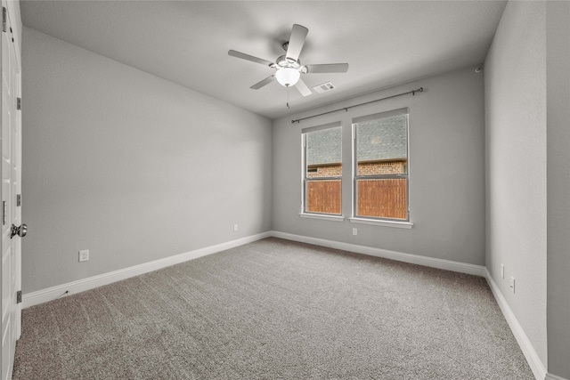 carpeted spare room with ceiling fan