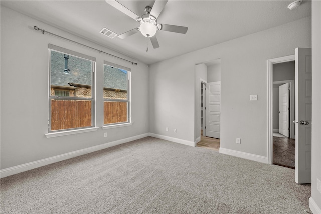 unfurnished bedroom featuring light carpet and ceiling fan