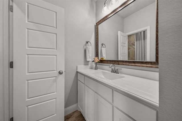 bathroom with vanity and hardwood / wood-style flooring