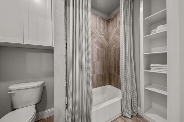 bathroom featuring toilet, shower / bath combination with curtain, and hardwood / wood-style flooring