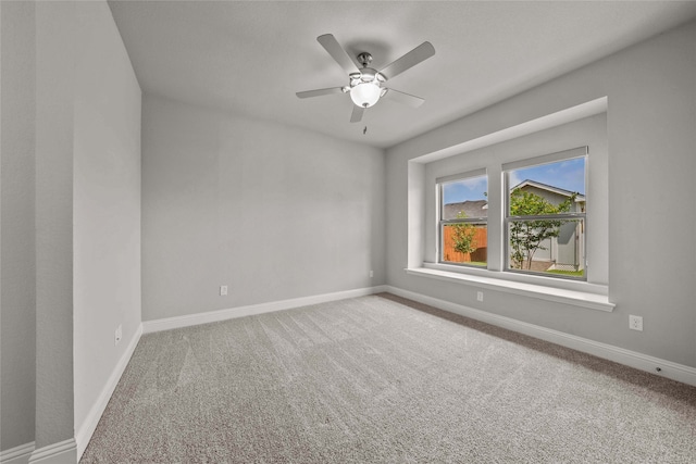 unfurnished room featuring ceiling fan and carpet