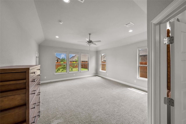 interior space with carpet flooring, ceiling fan, and vaulted ceiling