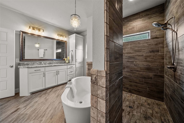 bathroom with shower with separate bathtub, vanity, and wood-type flooring