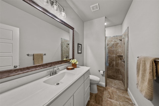 bathroom with a shower with door, vanity, and toilet