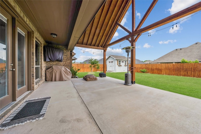 view of patio with a grill and a storage shed