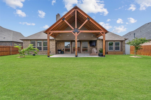 rear view of property featuring a patio area and a lawn