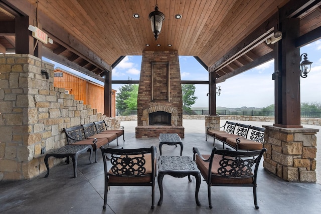 view of patio / terrace with an outdoor living space with a fireplace